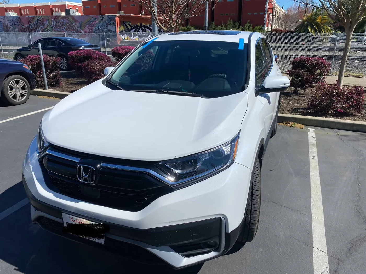 Freshly replaced windshield on a Honda CR-V in Lincoln, CA, blue tape marks the urethane cure
